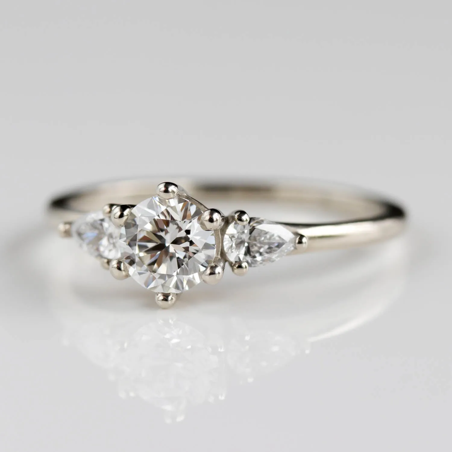 5mm Prong-set Three Stone Ring with Pear-Shaped Side Stones •